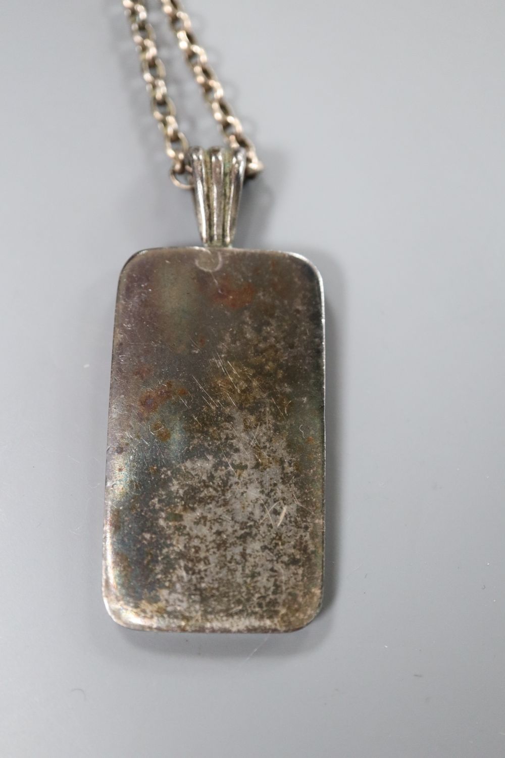 A brass Railway Timekeeper pocket watch, a 935 pocket watch and a silver ingot pendant.